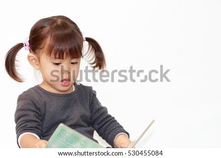 Japanese girl reading a picture book (2 years old)