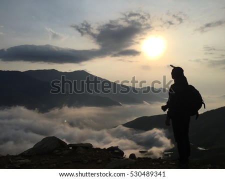 SonLa, VIetnam male traveler photographing in the mountain above clouds, Vietnam most view for travel checking on mountain.