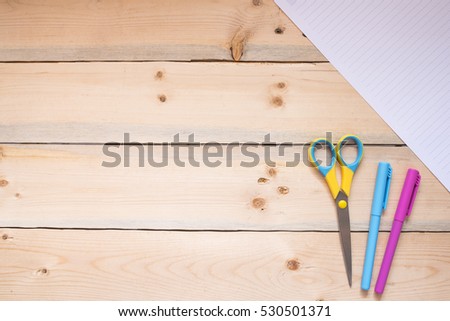 Back to school season with school and office supplies over wooden table. Top view with copy space.