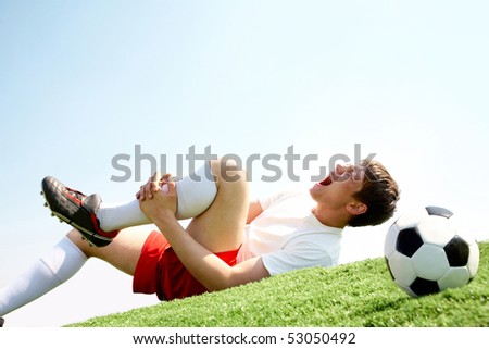 Image of soccer player lying down and shouting in pain Royalty-Free Stock Photo #53050492