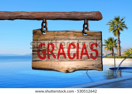 Gracias motivational phrase sign on old wood with blurred background