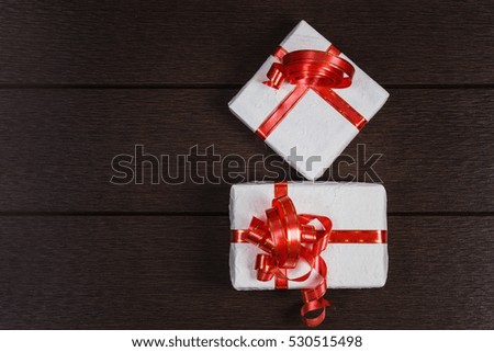 Gift boxes top view with copy space on dark table background, Presents with ribbon for christmas, valentine, birthday or new year for any holiday concept. View from above of photography.