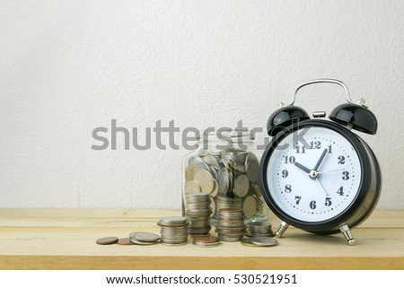 clock and stacks of coins for business money concept