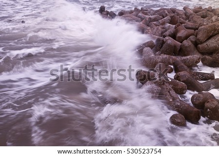 block breakwater hit by the sea