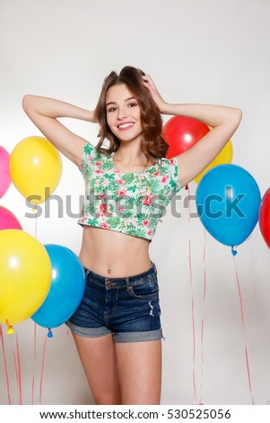 people, teens, holidays and party concept - happy smiling pretty teenage girl with helium balloons over gray background