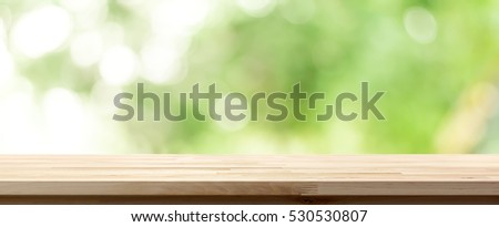 Wood table top on natural bokeh green background, panoramic banner - can be used for display or montage your products