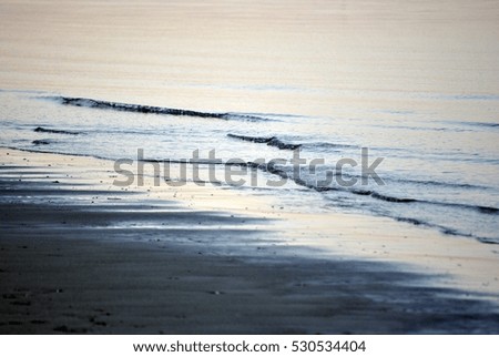 sea shore - water on the beach - blue wave along the shore - black and white