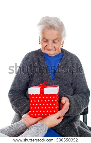Picture of an elderly woman receiving a Christmas gift