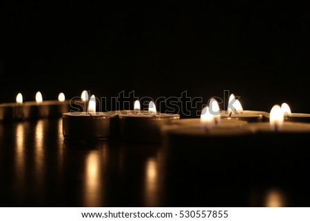 Many small candles in the dark