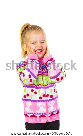 Little girl in pink sweater with patterns. Portrait happy kid in warm sweater.