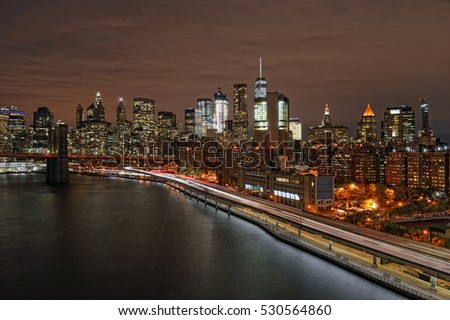 View of Lower Manhattan with Brooklyn Bridge and FDR Drive at night.