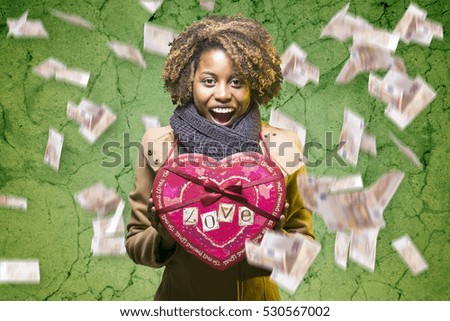Young black girl with Valentine's Day heart gift box