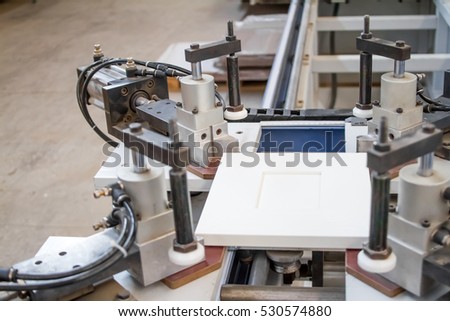 A machine for the production of furniture. Gluing under pressure. The door to the Cabinet. The industrial production. Furniture accessories.