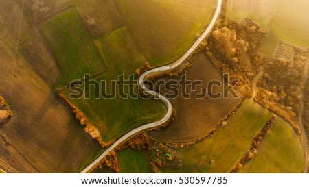 aerial S shaped composition with countryside road on hills in Italy province in Pavia