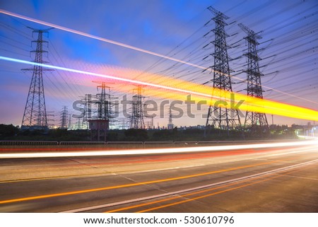High voltage, high speed road car track in the background of high voltage towers