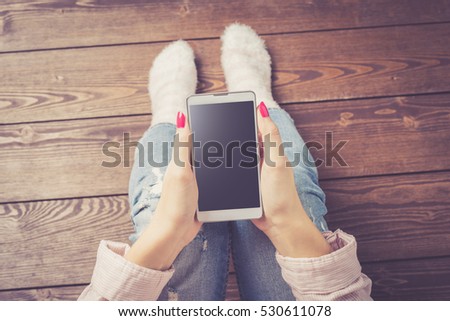 Woman using white smart phone. Close up