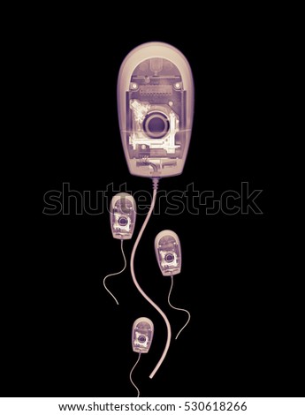 X RAY PHOTOGRAPHIC IMAGE OF FOUR COMPUTER MICE