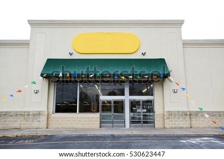 Storefront grand opening with blank yellow Sign and banner flags. Horizontal.