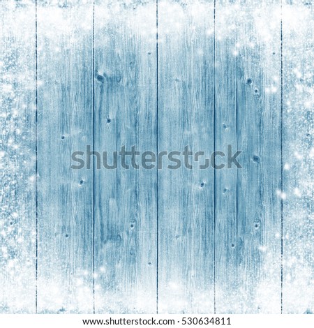 Light blue board with snow and frost. Winter Wooden background. Christmas. celebration. Cold. Snowfall. Frost. New Year. Card.