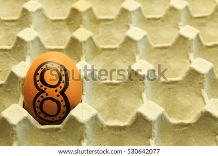 Brown eggs arranged in carton.