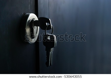 Keys stuck in a lock in vintage style Royalty-Free Stock Photo #530643055