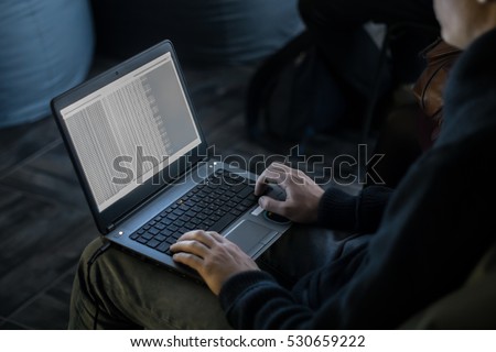 Russian hacker hacking the server in the dark Royalty-Free Stock Photo #530659222
