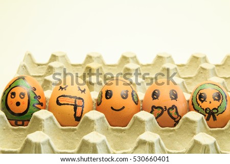 six brown eggs with faces drawn on christmas day.