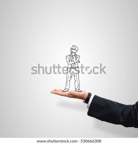 Drawn businessman in male palm on gray background