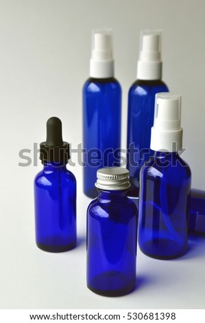 Group of dark blue glass bottle for cosmetic lotions, serums, oils and liquids