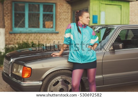 The girl in the nineties is about cars Royalty-Free Stock Photo #530692582