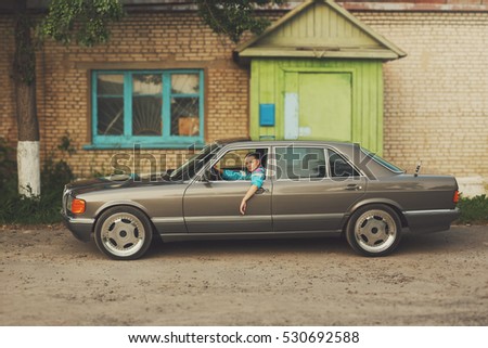 The girl in the nineties is about cars Royalty-Free Stock Photo #530692588
