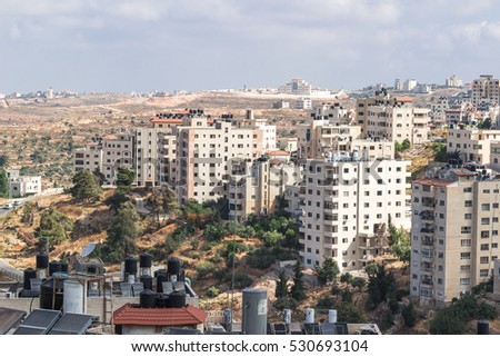 Picturesque skyline view on Palestinian territories lands from Ramallah, West Bank capital. Many Arabic houses and buildings running over the horizons on the olive hills