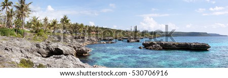 The rocky coastline along Tadine resort village on Mare island (New Caledonia). Royalty-Free Stock Photo #530706916