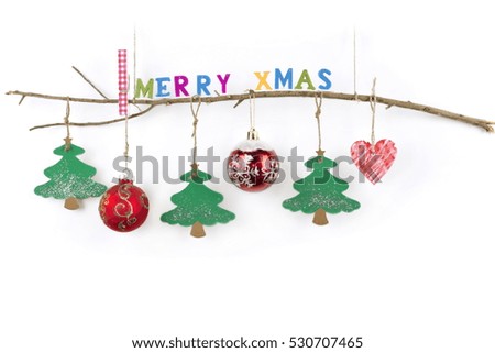 Christmas wooden thin branch with hanging toys and "Merry Xmas" greeting text written with small colorful letters on a pure white background