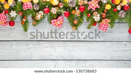 Christmas garland decoration placed on wooden planks. Copyspace for text