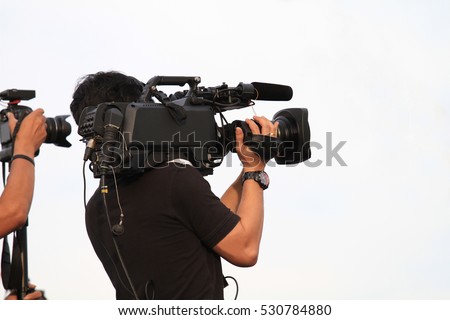 professional cameraman - covering on event with a video - with white background Royalty-Free Stock Photo #530784880