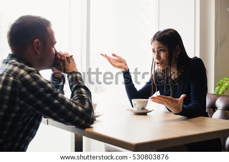 Young couple arguing in a cafe. Relationship problems. Royalty-Free Stock Photo #530803876