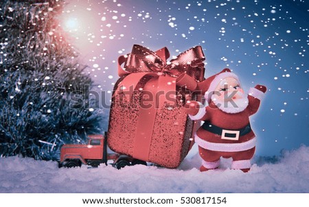 Santa with christmas gift in toy car 