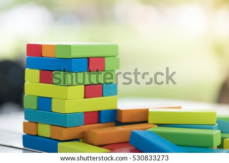 Colorful wood blocks stack game with copyspace, playing and learning background concept
