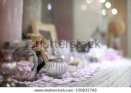 Beautiful vanity with purple flower petals and perfume bottles. Royalty-Free Stock Photo #530835760