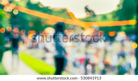 abstract blur image of  day festival  in garden with bokeh for background usage . (vintage tone)