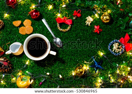 Coffee Break and mini cookies in Christmas day on green grass. Morning sunshine day and good day. Happy time together in winter season.Top view