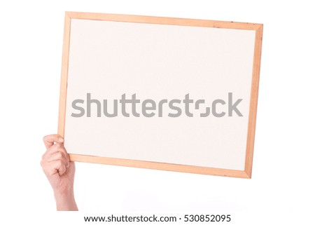 women's hand holding a blank sign