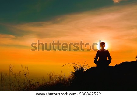 Yoga practicioner during the sunset meditation Royalty-Free Stock Photo #530862529
