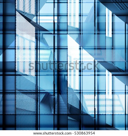 Close-up photo of modern multistory building fragment with supporting beams and windows. Transparent contemporary architecture in hi-tech / minimalism style.