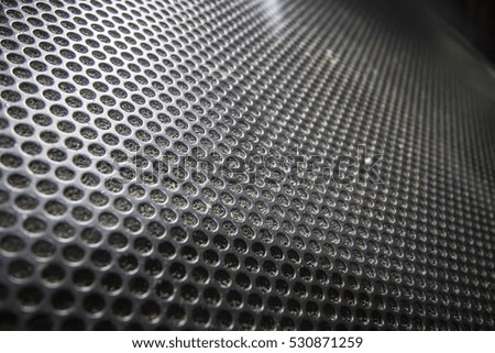 Black speaker lattice background, close-up