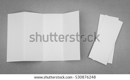 Four - fold white template paper on gray background