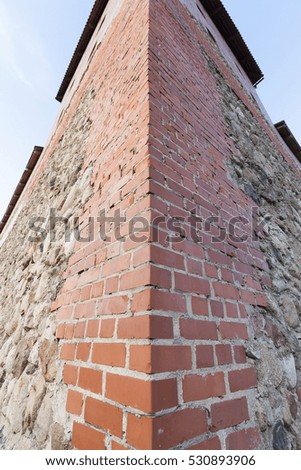  photographed close up with some details of the old fortress, located in the city of Lida, Belarus. Blue sky in the background