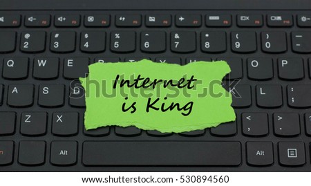 Torn paper on keyboard with word internet is king