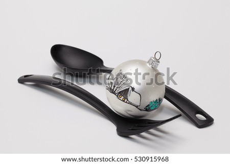 Black fork and spoon and christmas decoration on the white table